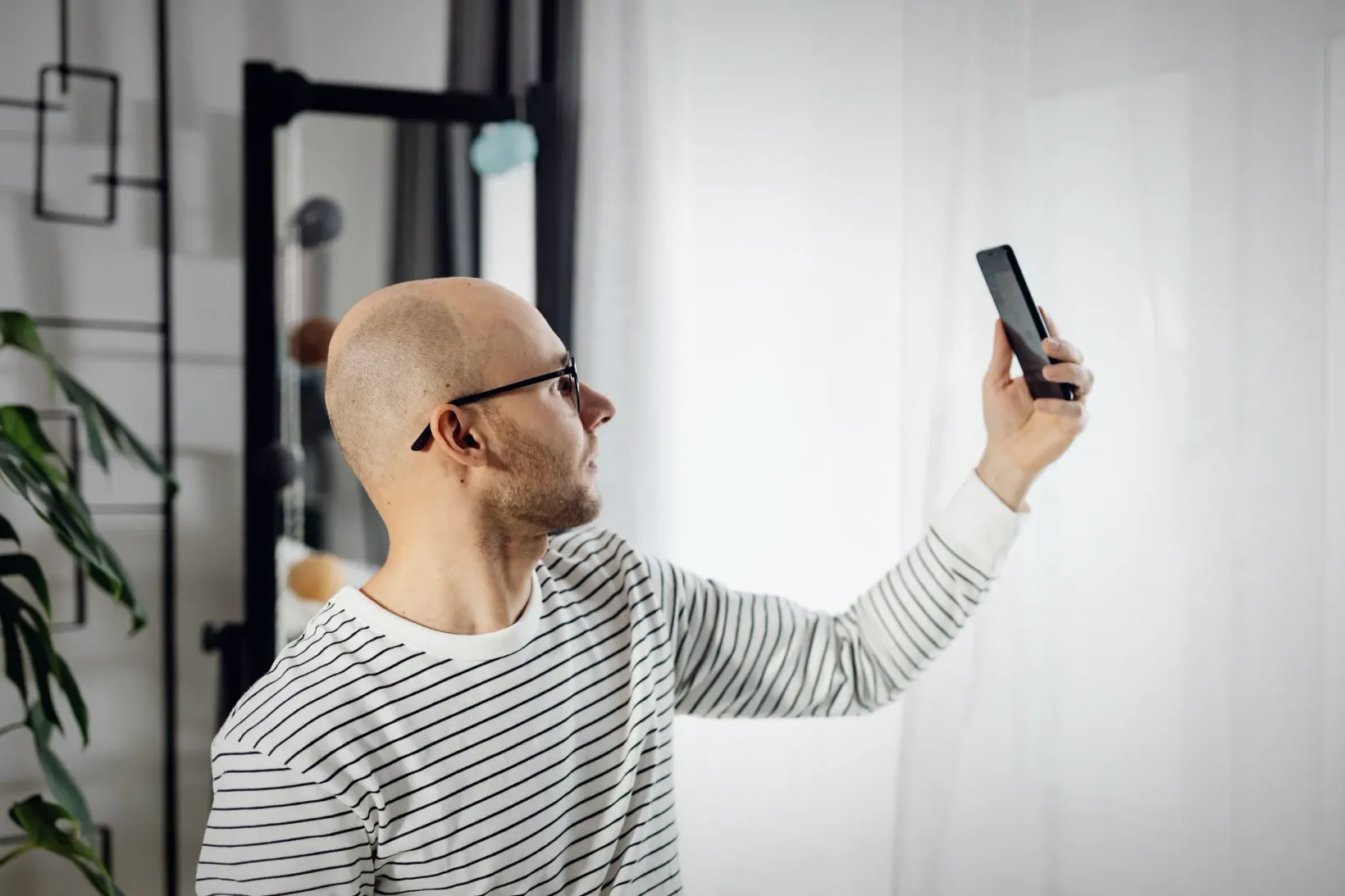 A man in his forties on a video call with his doctor at home